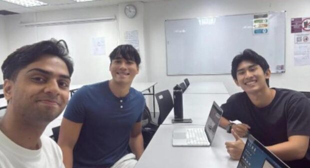 Founders meeting around a table in a campus classroom