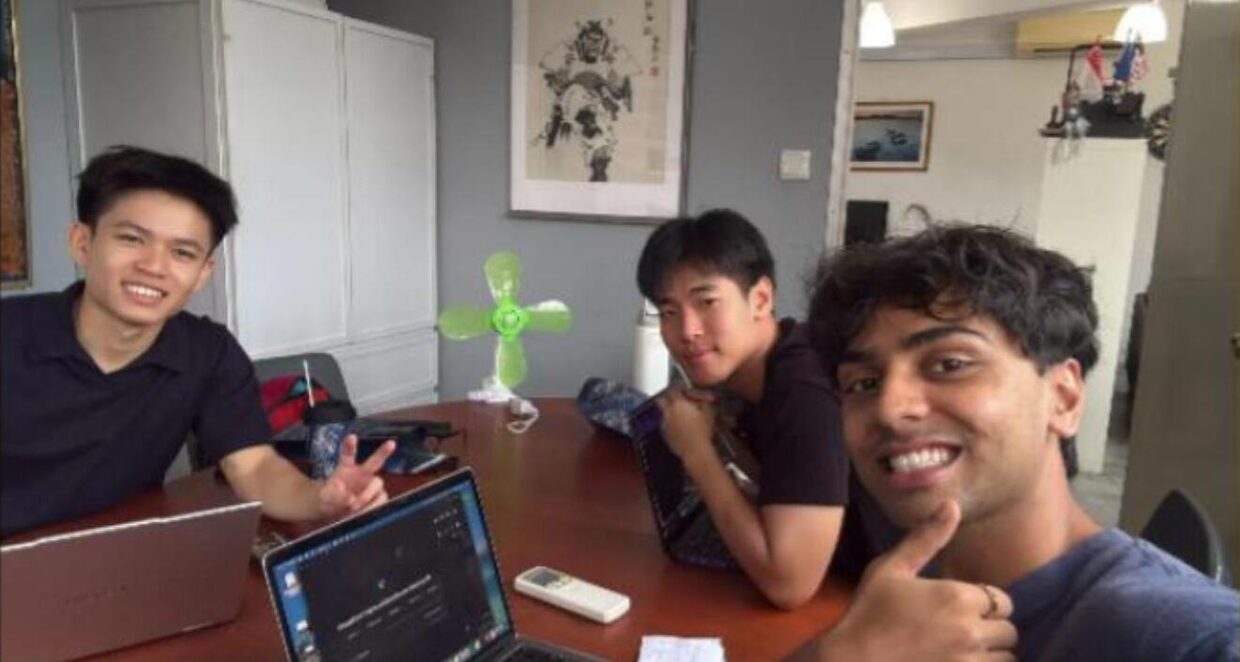 Three Apex Venture Club founders working together around a table at the office